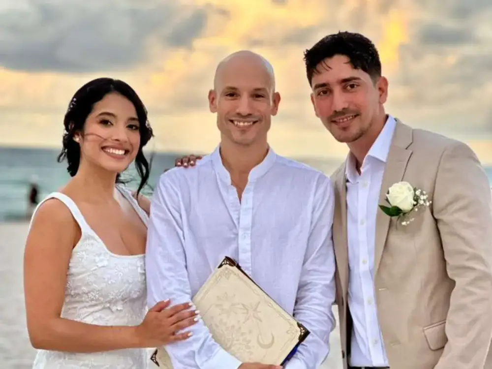 Bride and groom with their Miami Beach wedding officiant at sunset