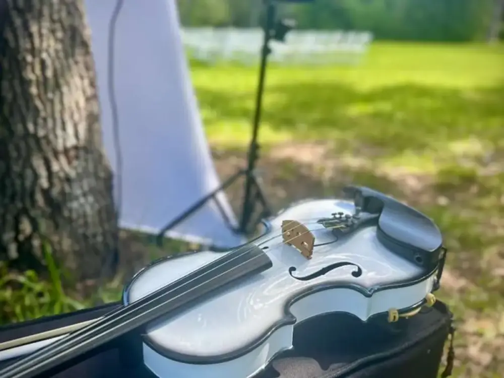 White violin ready for live ceremony music at an outdoor Miami wedding
